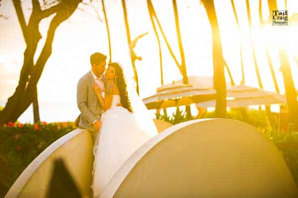 bride and groom holding each other at sunset at the bridge at the Hyatt Regency Maui Resort & Spa