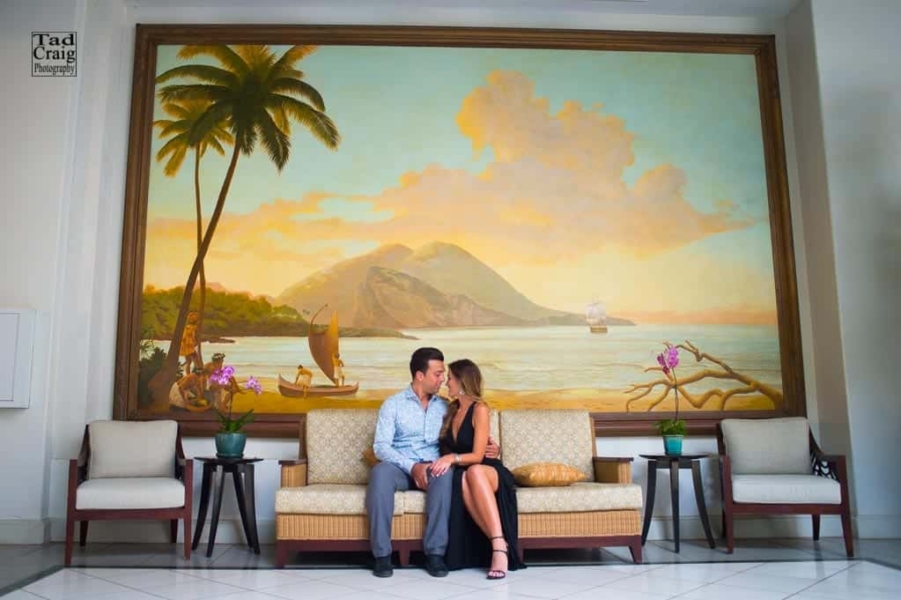 Couple sitting in front a pretty painting at the Fairmont Kea Lani Hotel, Maui Hawaii