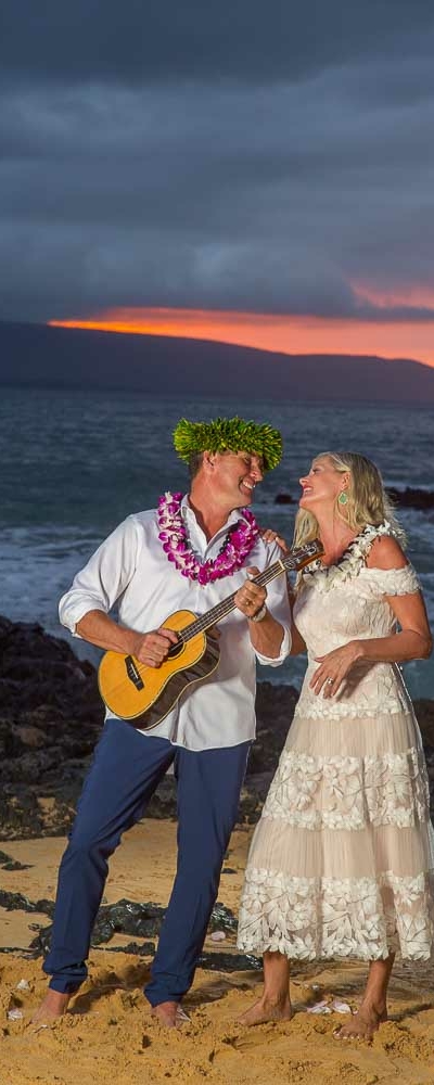 Happy Couple enjoying sunset after saying their vows on a beach in Maui