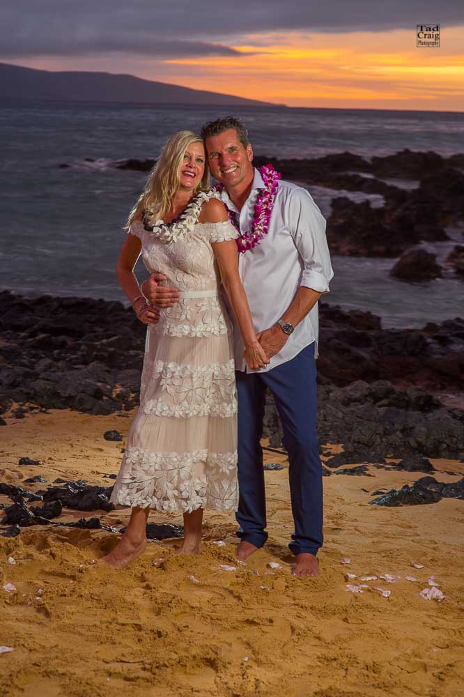 Happy Couple enjoying sunset after saying their vows on a beach in Maui