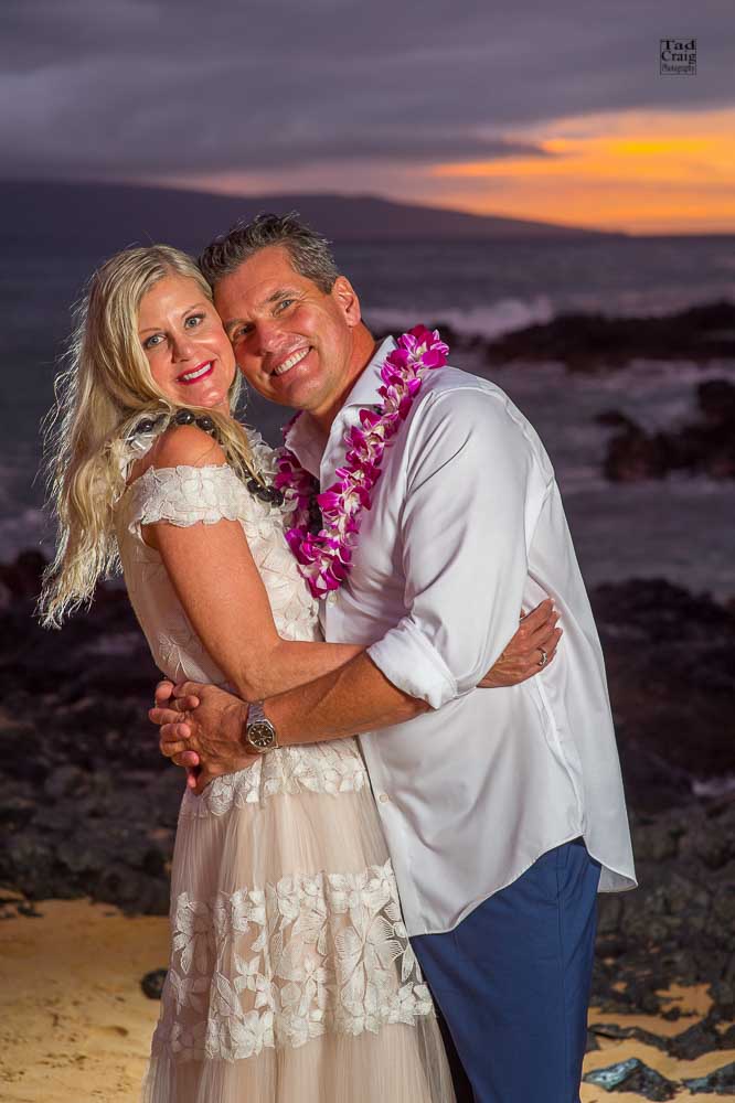 Happy Couple enjoing sunset after saying their vows on a beach in Maui