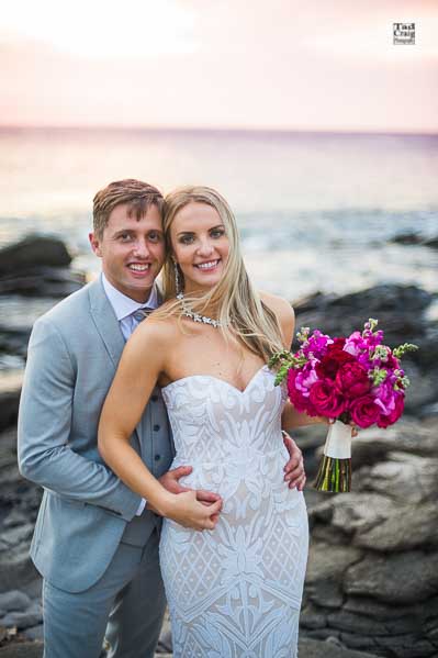 Happy Just Married Couple on Rocks looking in camera